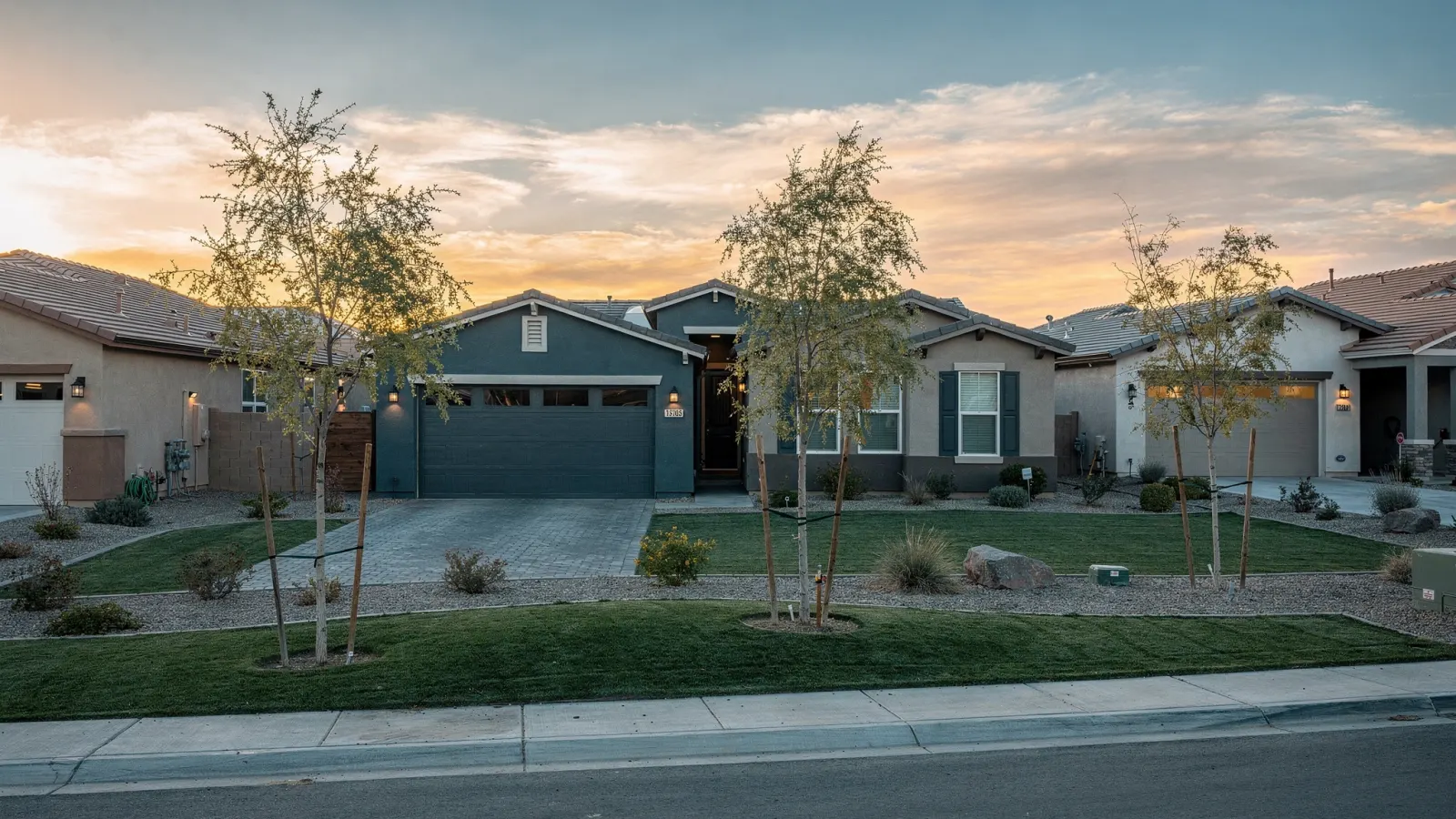 Avondale Arizona suburban neighborhood of desert homes with young trees at sunset