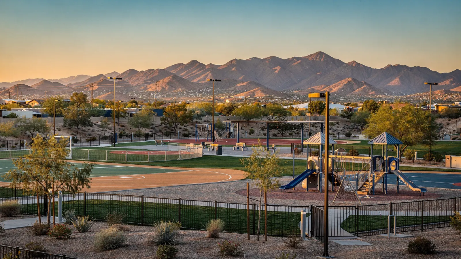Surprise Arizona community park with ball fields, playground and the White Tank Mountains at sunset